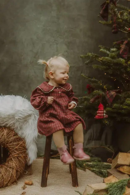 Child by the Christmas tree