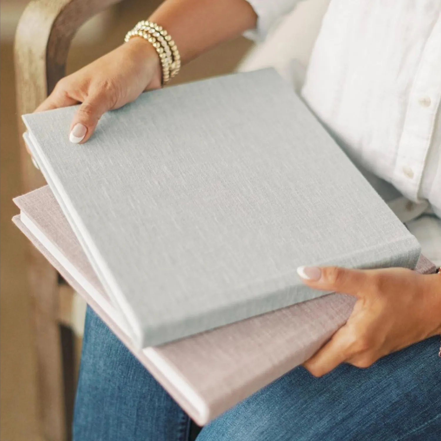 Grey linen album held in two hands