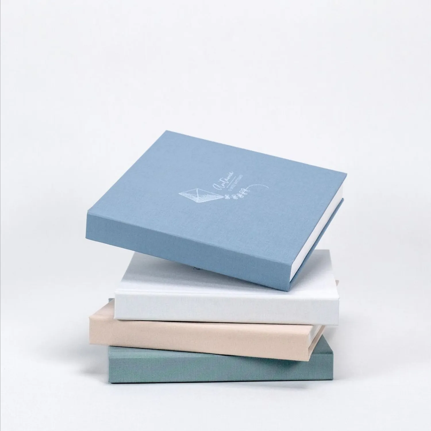 Light blue linen album on a stack of albums